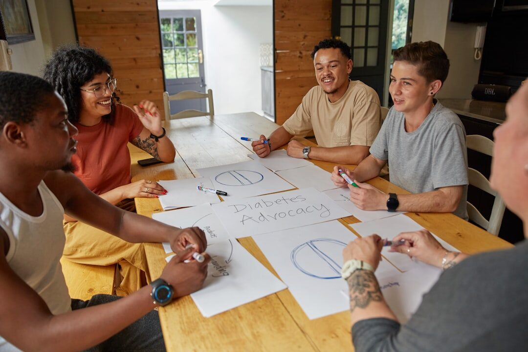 Editorial team having a meeting around a table with layouts